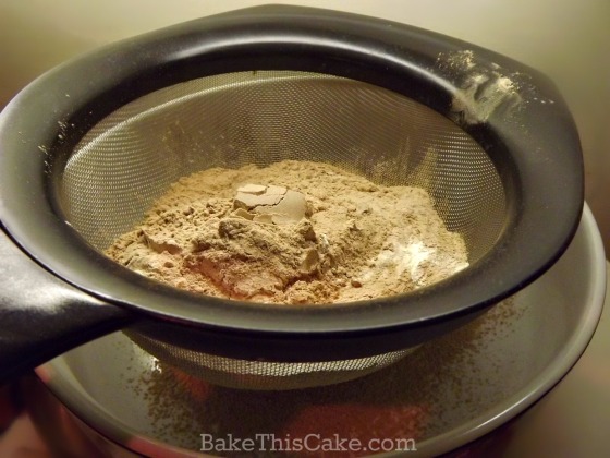 Sifting cocoa and flour for chcolate wine cake recipe by bake this cake
